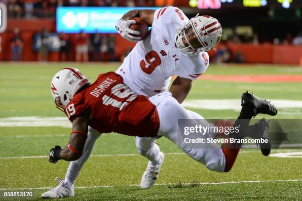 Defensive back Marquel Dismuke of the Nebraska Cornhuskers tackles running back Rachid Ibrahim of the Wisconsin Badgers at Memorial Stadium on...