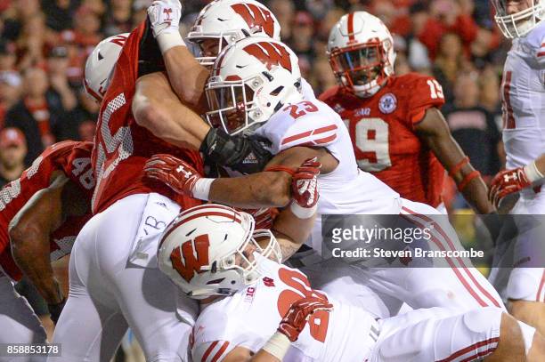 Running back Jonathan Taylor of the Wisconsin Badgers reaches across the goal line to score against the Nebraska Cornhuskers at Memorial Stadium on...