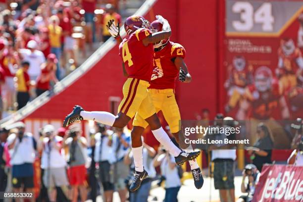 Steven Mitchell Jr. #4 and Tyler Vaughns of the USC Trojans celebrate a first quarter touch down against the Oregon State Beavers at Los Angeles...