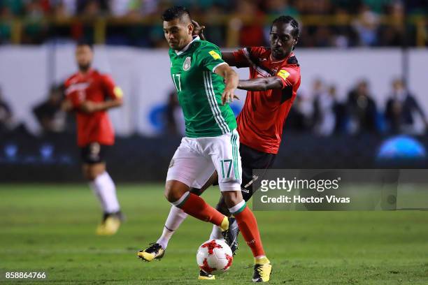 Jesus Corona of Mexico struggles for the ball with Nathan Lewis of Trinidad & Tobago during the match between Mexico and Trinidad & Tobago as part of...