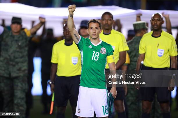 Andres Guardado of Mexico rises his fist during the minute of silence for the victims of the earthquake that struck Mexico last September 19 prior...