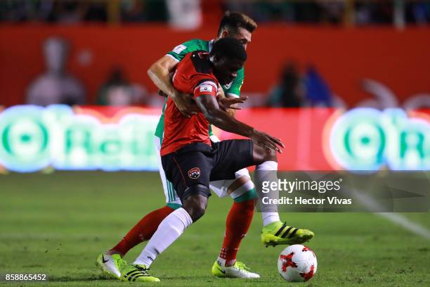 Hector Herrera of Mexico struggles for the ball with Kareem Moses of Trinidad & Tobago during the match between Mexico and Trinidad & Tobago as part...