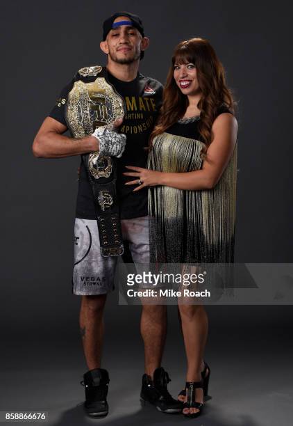 Interim lightweight champion Tony Ferguson poses for a portrait backstage with his wife Cristina Servin after his victory over Kevin Lee during the...