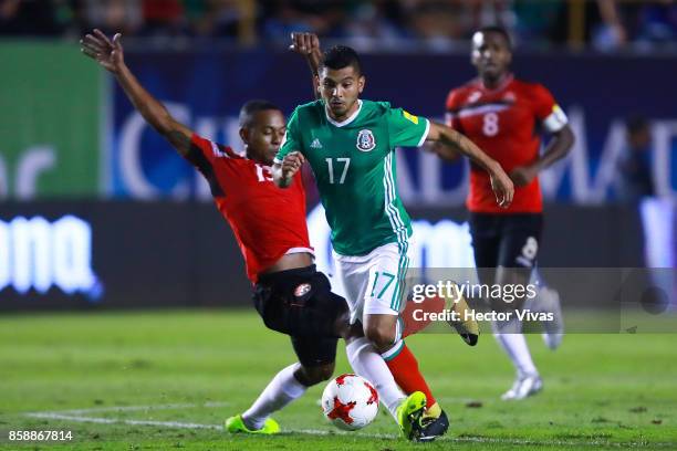 Jesus Corona of Mexico struggles for the ball with Curtis Gonzalez of Trinidad & Tobago during the match between Mexico and Trinidad & Tobago as part...