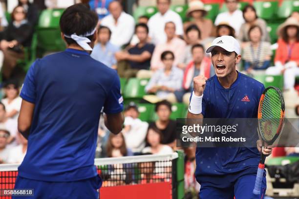 Ben McLachlan of Japan celebrates with doubles partner Yasutaka Uchiyama of Japan in their men's doubles final match against Jamie Murray of Great...