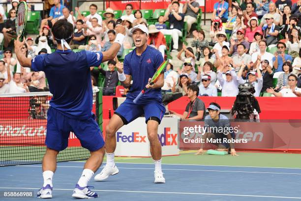 Ben McLachlan of Japan celebrates victory with doubles partner Yasutaka Uchiyama of Japan in their men's doubles final match against Jamie Murray of...