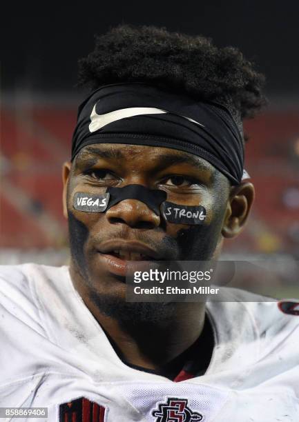 Running back Rashaad Penny of the San Diego State Aztecs wears eye black stickers with the words "Vegas Strong" on them as he is interviewed on the...