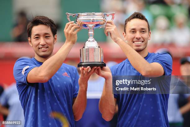 Yasutaka Uchiyama of Japan and doubles partner Ben McLachlan of Japan hold the winners trophy after their men's doubles final match against Jamie...