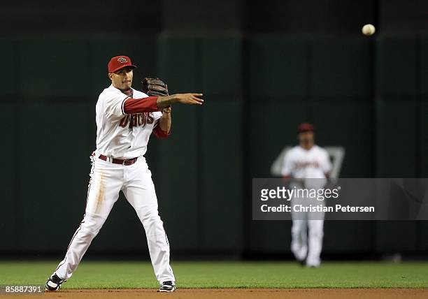 Infielder Felipe Lopez of the Arizona Diamondbacks fields a ground ball out against the Colorado Rockies during the game at Chase Field on April 8,...