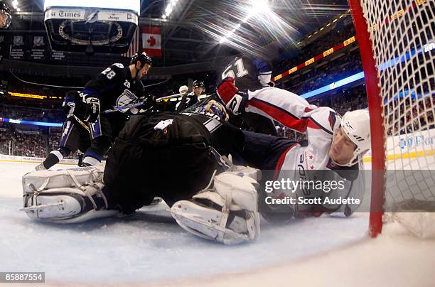 Goaltender Karri Ramo of the Tampa Bay Lightning makes a save against Brooks Laich of the Washington Capitals in front of the net at the St. Pete...