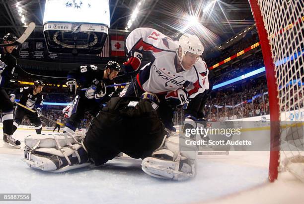 Goaltender Karri Ramo of the Tampa Bay Lightning makes a save against Brooks Laich of the Washington Capitals in front of the net at the St. Pete...