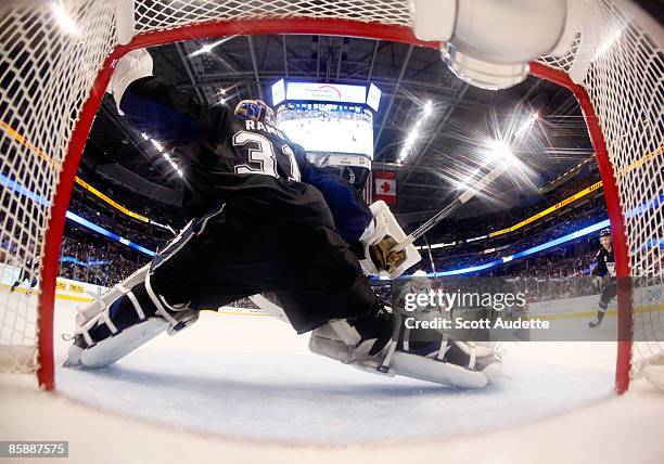 Goaltender Karri Ramo of the Tampa Bay Lightning makes a save against Matt Bradley of the Washington Capitals at the St. Pete Times Forum on April 9,...