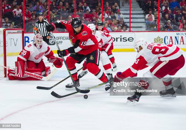 Ottawa Senators Left Wing Zack Smith battles for the puck with Detroit Red Wings Defenceman Trevor Daley in front of Detroit Red Wings Goalie Jimmy...