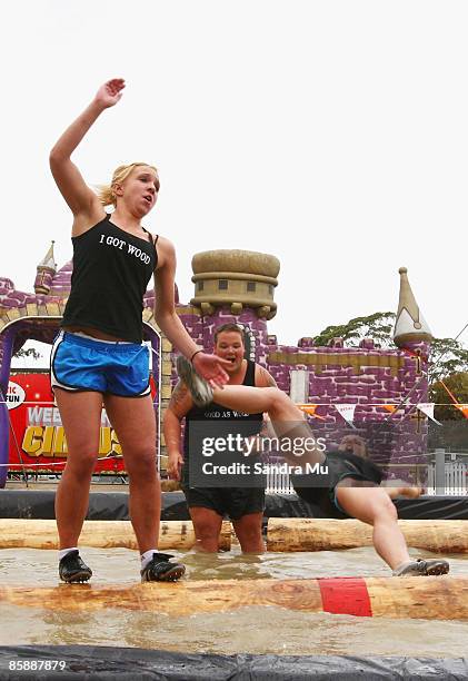 Shana Martin falls off the log making Olivia Judd the winner during the boom run in the lumber jack show at the Royal Easter Show at the ASB...