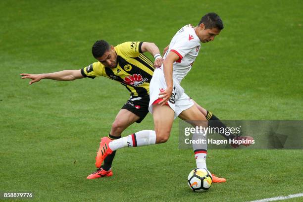 Ali Abbas of the Phoenix tackles Karim Matmour of Adelaide United during the round one A-League match between Wellington Phoenix and Adelaide United...