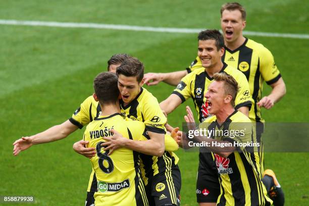 Dario Vidosic of the Phoenix celebrates with teammates after scoring a goal during the round one A-League match between Wellington Phoenix and...