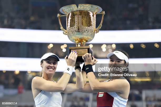 Yung-Jan Chan of Chinese Taipei and Martina Hingis of Switzerland pose for a picture holding the winners trophy after winning the Women's Doubles...