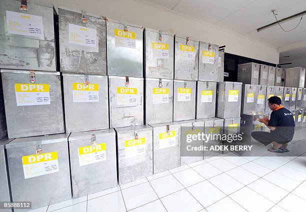 An official of electoral commission checks sealed ballot boxes at a subdistrict office in Jakarta on April 10 before a national tabulation which will...