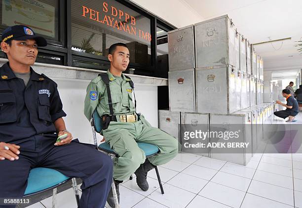Two security personal guard sealed ballot boxes at a subdistrict office in Jakarta on April 10 before a national tabulation which will start today....