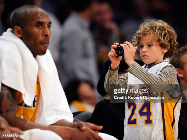 KDuke Keaton son of actress Diane Keaton takes picture of Kobe Bryant of the Los Angeles Lakers during a break in the action against the Denver...