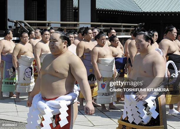 Mongolian sumo grand champions , Asashoryu and Hakuho walk before other sumo wrestlers after their prayers during the "Honozumo," a ceremonial sumo...