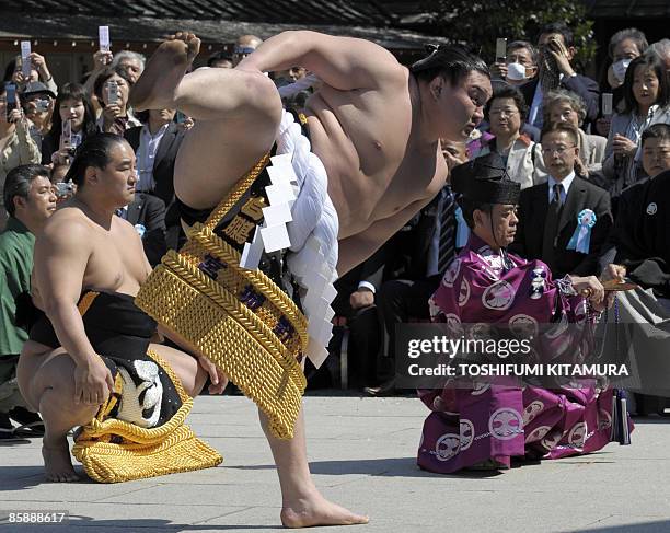 Mongolian sumo grand champion Hakuho offers a ritual entrance into the ring during the "Honozumo," a ceremonial sumo tournament, at the Yasukuni...