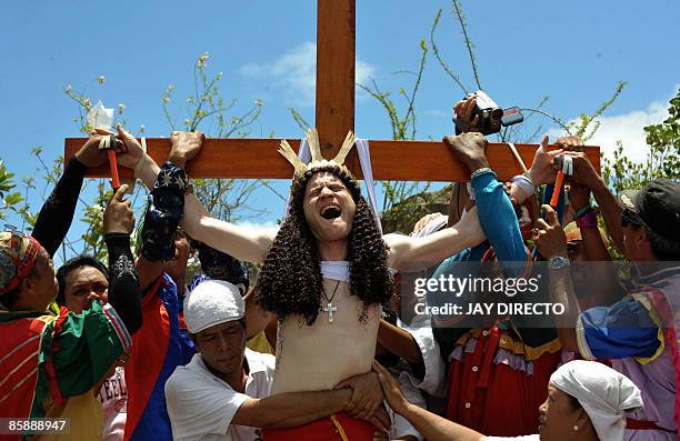 Australian John Michael has his hands nailed to the cross in an imitation of Christ's death as part of Good Friday rituals in Kapitangan town,...