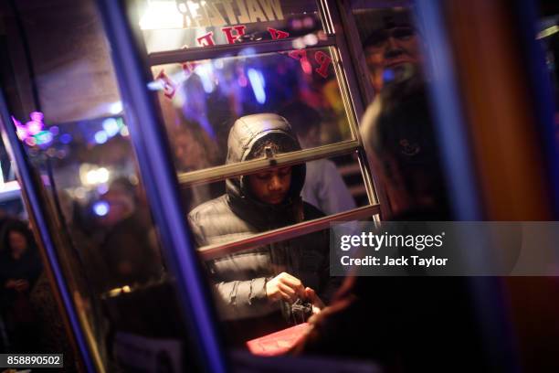 Visitor purchases a ticket for a ride at the Nottingham Goose Fair in the Forest Recreation Ground on October 7, 2017 in Nottingham, England. The...