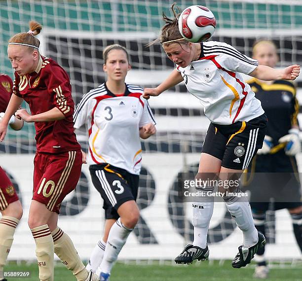 Anna Cholovyaga of Russia, Laura Vetterlein and Claudia Götte of Germany jump for a header during the U17 Women international friendly match between...