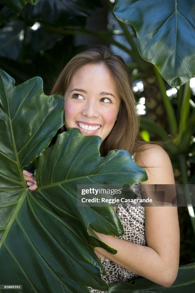 Young asian girl standing in leaves