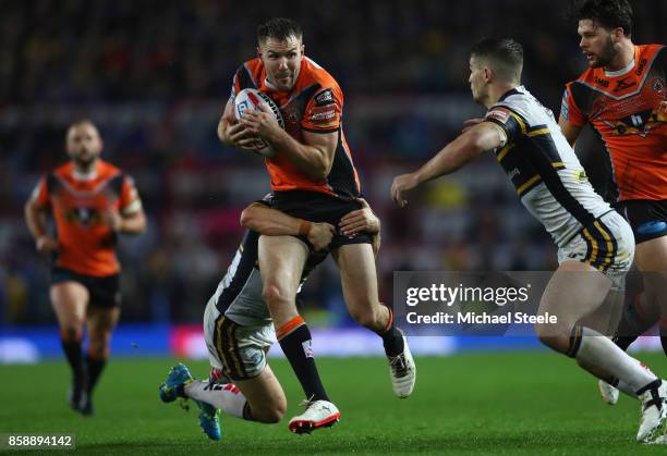 Michael Shenton of Castleford is tackled by Danny McGuire of Leeds during the Betfred Super League Grand Final between Castleford Tigers and Leeds...