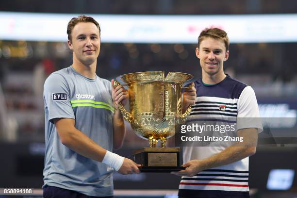 Henri Kontinen of Finland and John Peers of Australia hold the winners trophy after winning the Mens's doubles final against Jack Sock and John Isner...