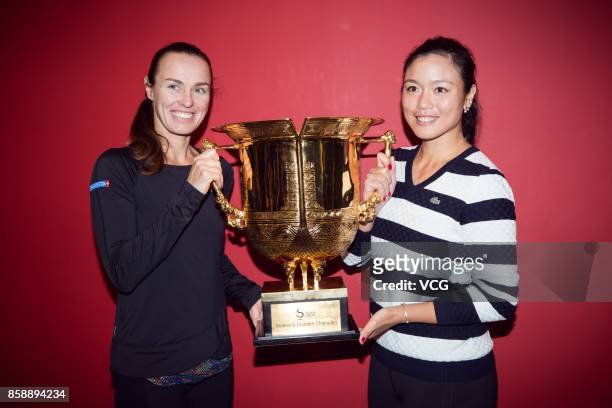 Yung-Jan Chan of Chinese Taipei and Martina Hingis of Switzerland pose with the trophy after winning the Women's doubles final match against Timea...