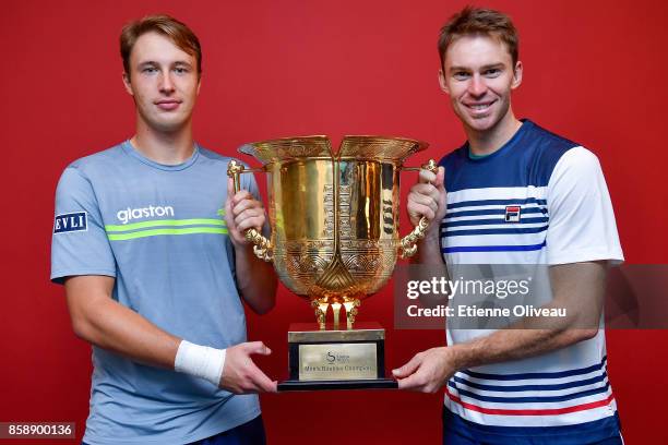 Henri Kontinen of Finland and John Peers of Australia pose for a picture holding the winners trophy after winning the Men's Doubles Final against...