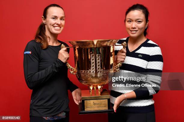 Yung-Jan Chan of Chinese Taipei and Martina Hingis of Switzerland pose for a picture holding the winners trophy after winning the Women's Doubles...