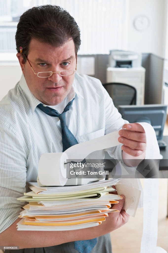 Accountant with papers and adding machine