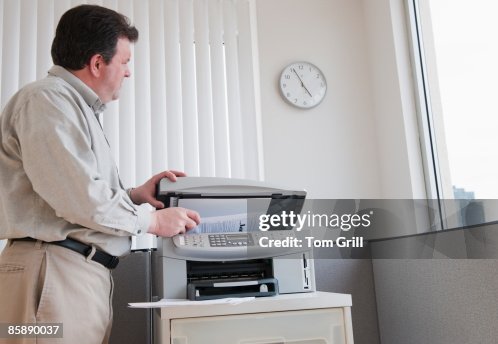 Office worker using copy machine Office worker using copy machine