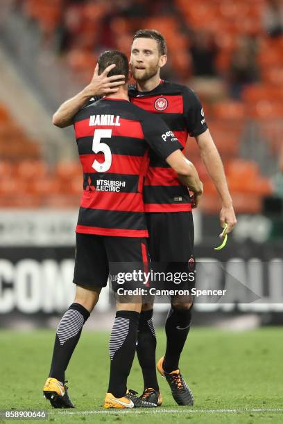 Brendan Hamill of the Wanderers and Robert Cornthwaite of the Wanderers embrace after winning the round one A-League match between the Western Sydney...