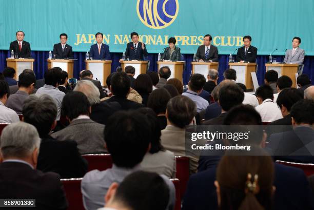Shinzo Abe, Japan's prime minister and president of the Liberal Democratic Party , fourth left, speaks as Tadatomo Yoshida, president of the Social...