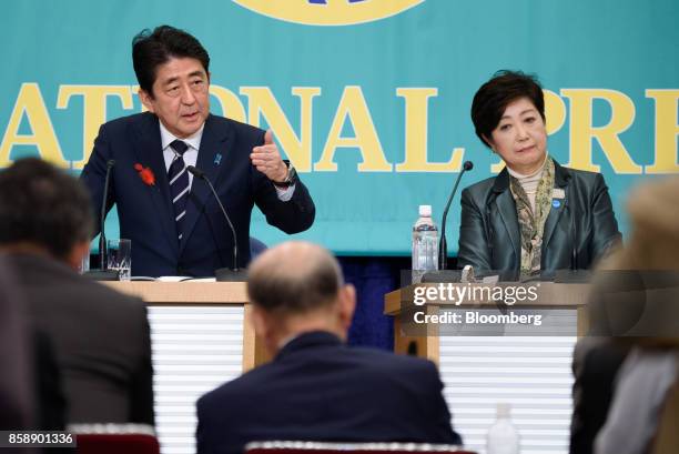 Shinzo Abe, Japan's prime minister and president of the Liberal Democratic Party , left, speaks as Yuriko Koike, governor of Tokyo and head of the...