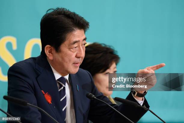 Shinzo Abe, Japan's prime minister and president of the Liberal Democratic Party , left, speaks as Yuriko Koike, governor of Tokyo and head of the...