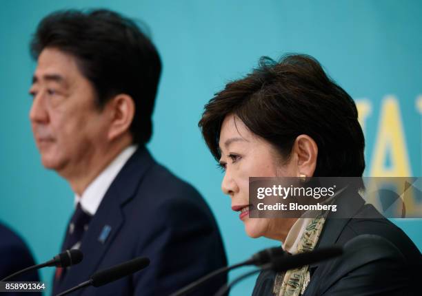Yuriko Koike, governor of Tokyo and head of the Party of Hope, right, speaks as Shinzo Abe, Japan's prime minister and president of the Liberal...