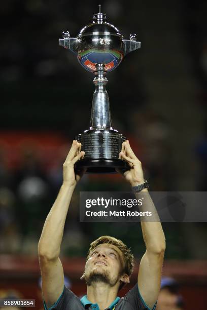 David Goffin of Belgium holds the winners trophy aloft after his men's final match against Adrian Mannarino of France during day seven of the Rakuten...