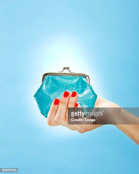 woman holding change purse - blue purse stock pictures, royalty-free photos & images