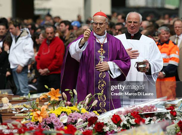 Cardinal Tarcisio Bertone Vatican Secretary of State blesses the coffins of the victims of the earthquake in Southern Italy during the funeral at the...