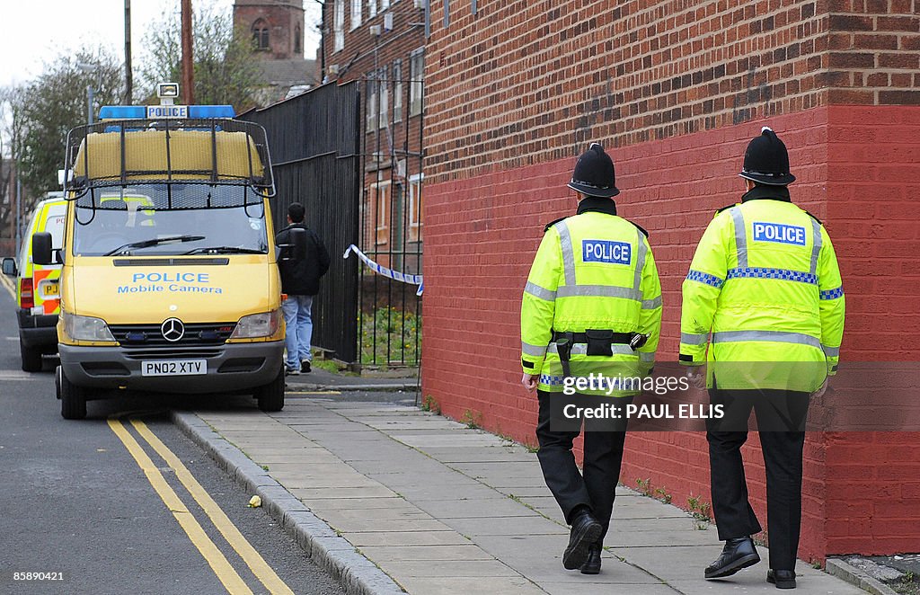 Police officers patrol the area around a