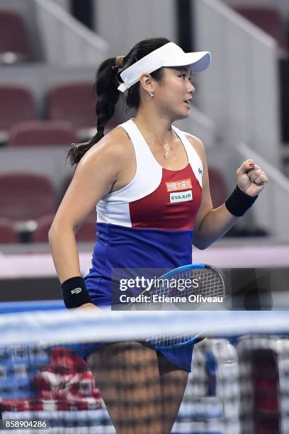 Yung-Jan Chan of Chinese Taipei, partner of Martina Hingis of Switzerland, celebrates a point during their Women's doubles final match against Timea...