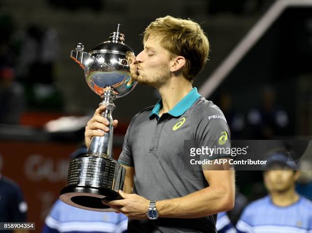 David Goffin of Belgium kisses the trophy during the awarding ceremony after their men's singles final match against Adrian Mannarino of France in...