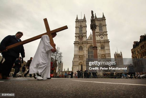 Man from The Passage, a day centre for homeless people, carries a cross past Westminster Abbey on April 10, 2009 in London. As part of London's...