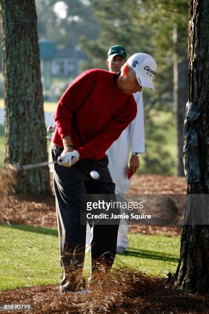 Larry Mize plays a shot left-handed from the pine needles on the first hole during the second round of the 2009 Masters Tournament at Augusta...